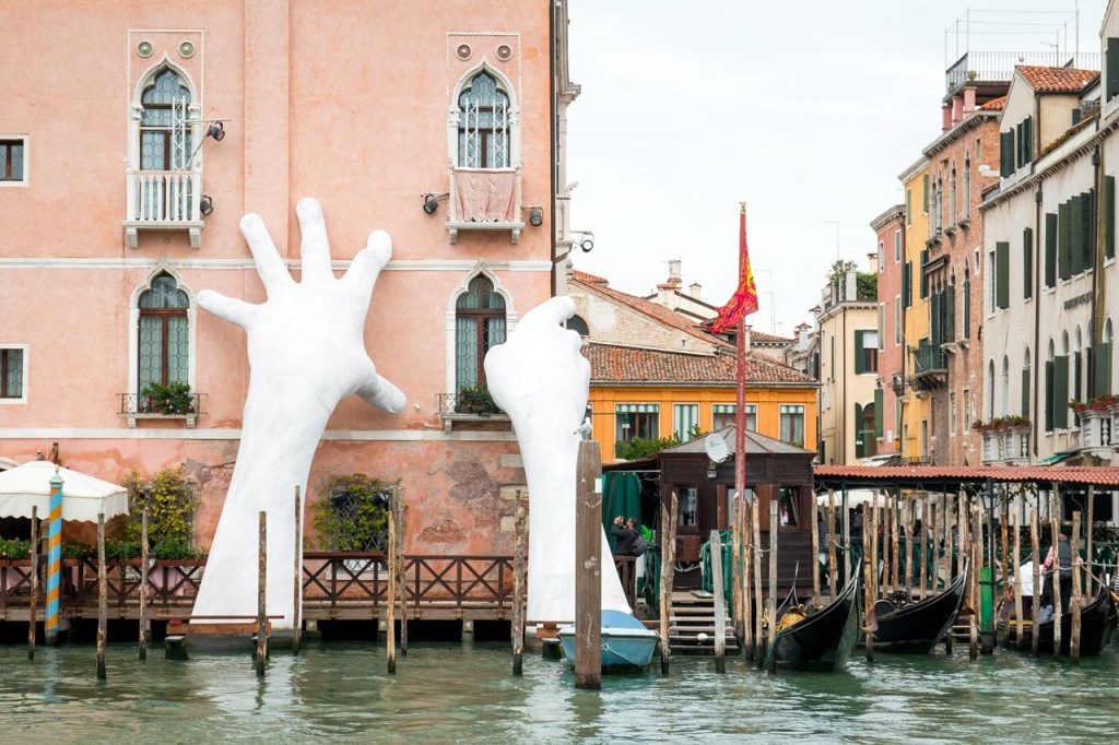 Financial support - image of two large hands supporting a building
